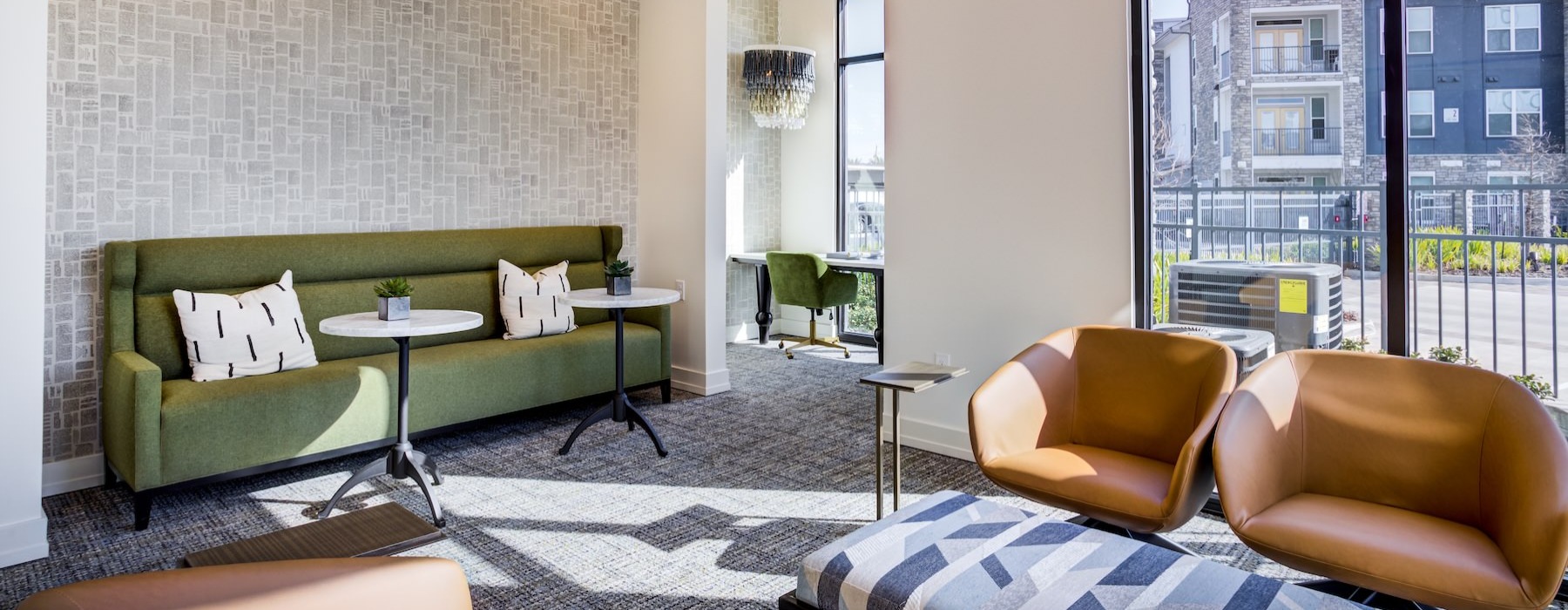 a clubroom with a couch, tables and chairs